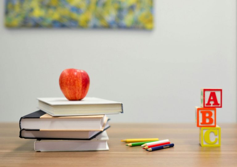 classroom with a book and an apple on top of depicting the schools in Iredell County